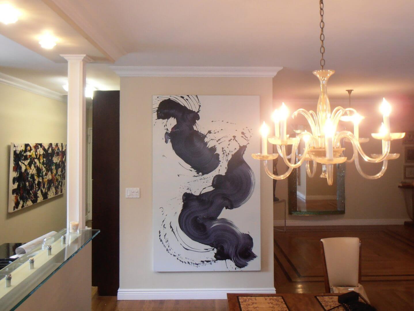 Modern abstract painting and elegant chandelier in a sophisticated interior, available at Chelsea Art Group - New York City top trusted art advisers.