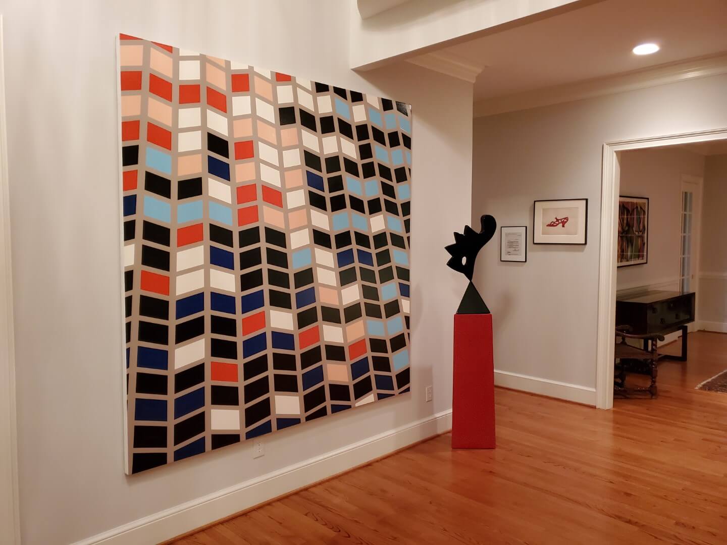 Abstract geometric painting and modern sculpture in a contemporary interior, available at Chelsea Art Group - New York City top trusted art advisers.
