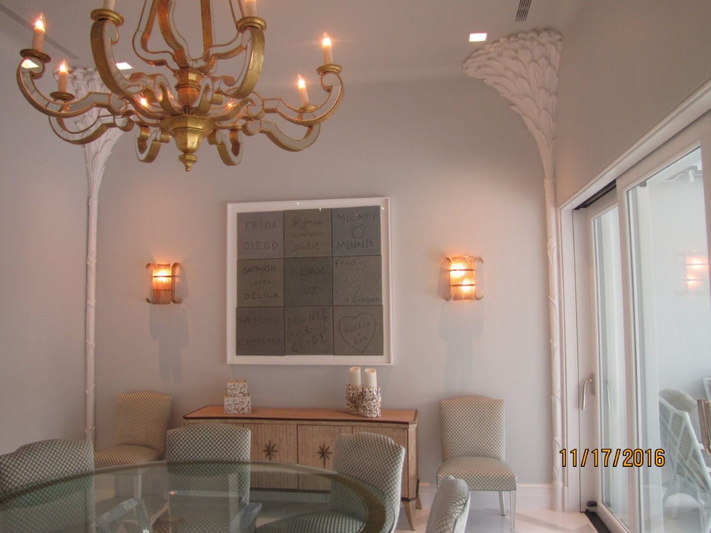 Elegant dining room with framed artwork, chandelier, and modern chairs, only available at Chelsea Art Group - New York City top trusted art advisers.