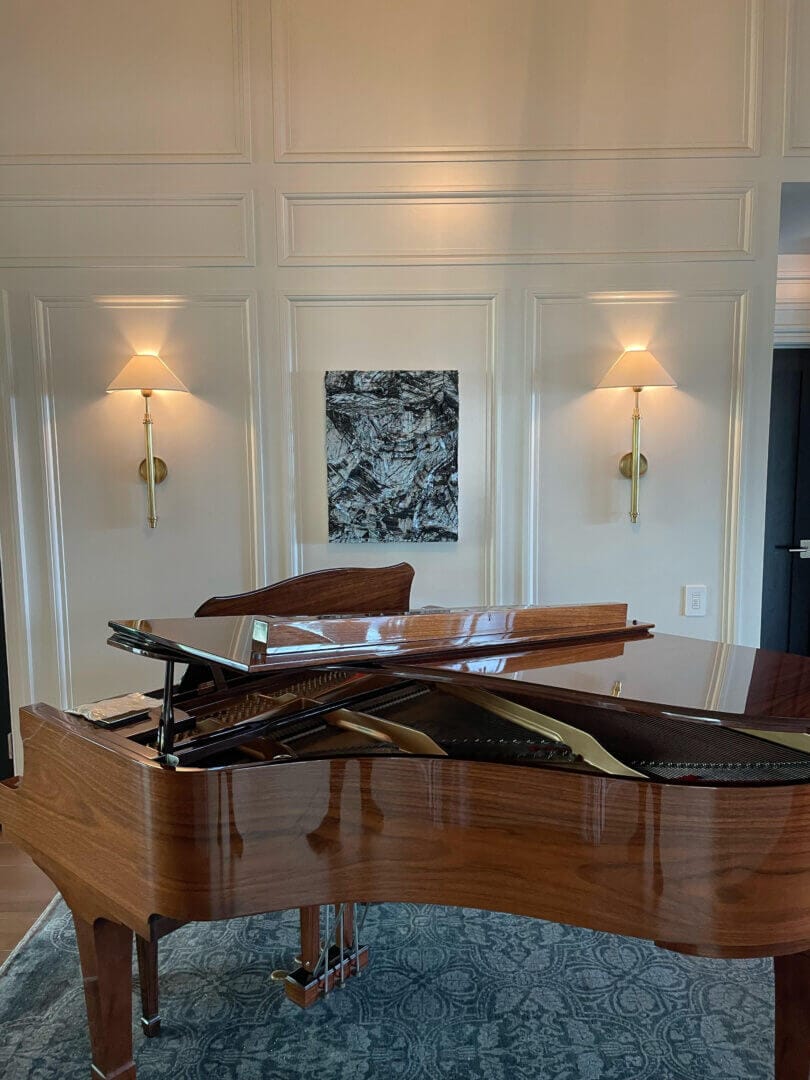 Elegant grand piano and abstract artwork in refined interior, only available at Chelsea Art Group - New York City top trusted art advisers.
