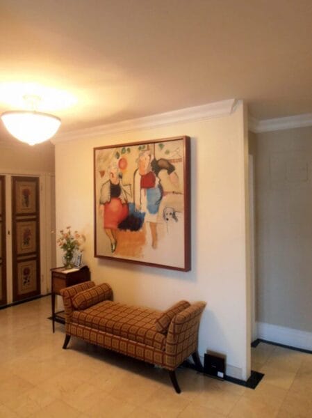 Colorful abstract painting on a wall above a patterned bench, available at Chelsea Art Group - New York City top trusted art advisers in conceptual art.